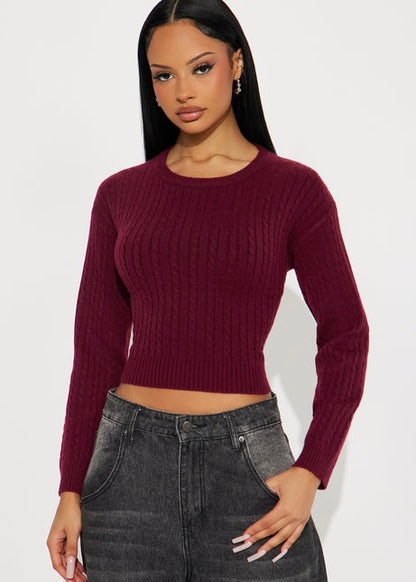 Burgundy cable knit sweater with fitted waist, long sleeves and crew neckline